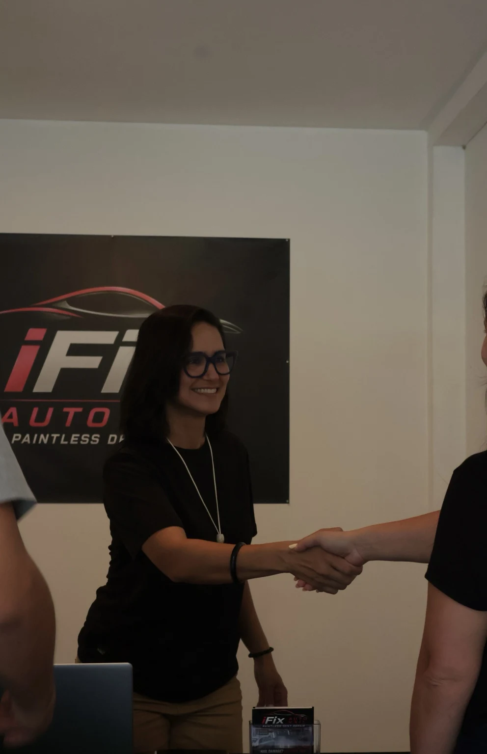iFix Auto Hail team member greeting a customer